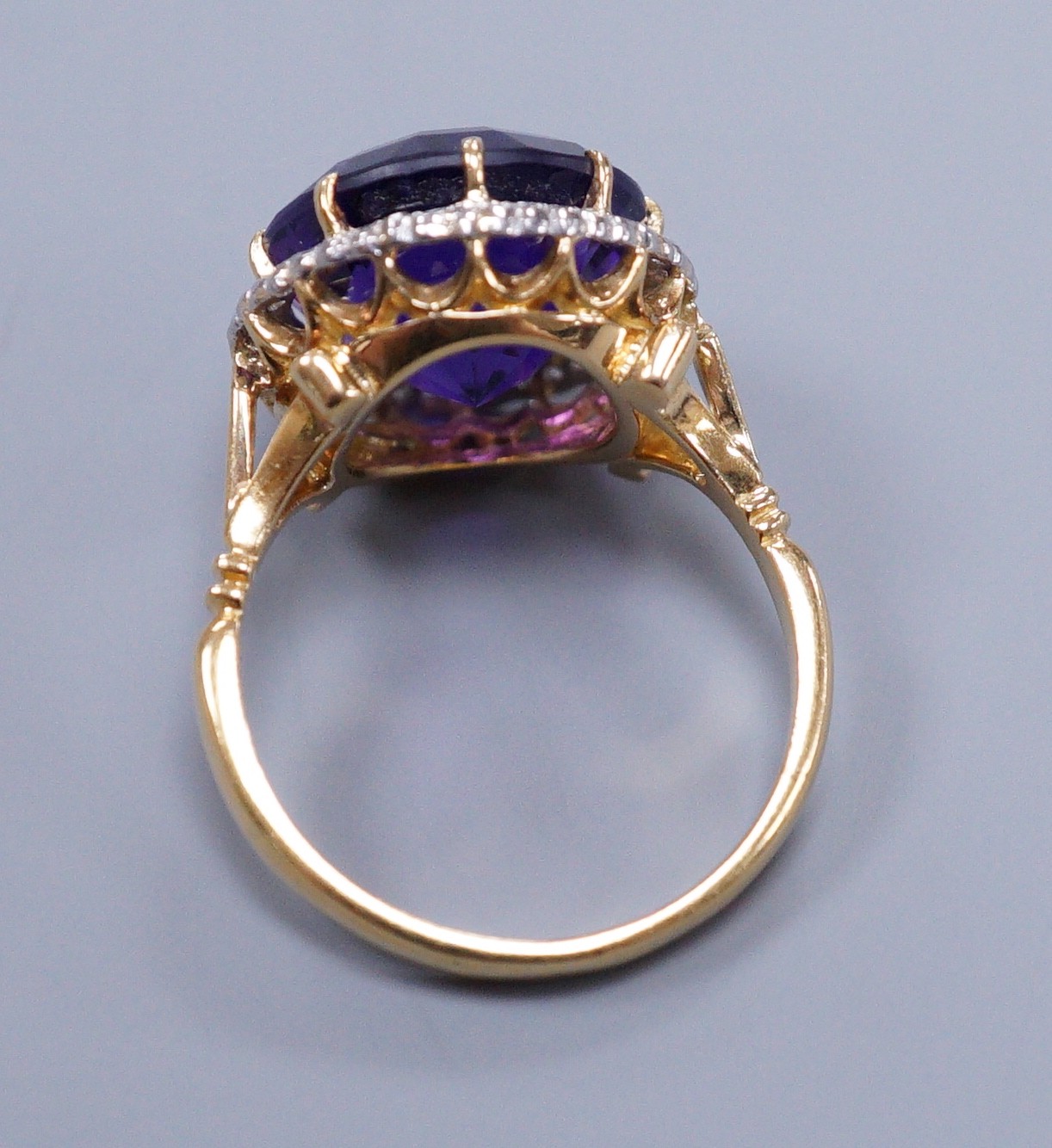 An 18ct gold and platinum, amethyst and diamond circular cluster ring, size M, gross 5.7 grams